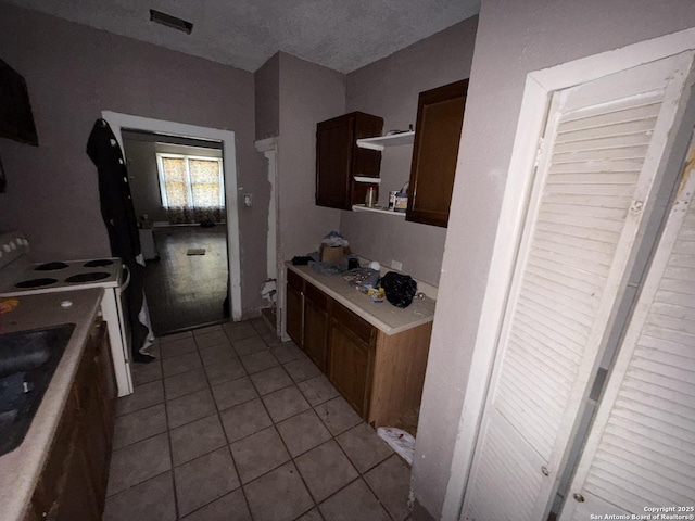918 Potomac, San Antonio, TX 78202 - kitchen with electric range, light countertops, light tile patterned floors, and open shelves