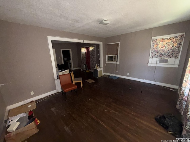 918 Potomac, San Antonio, TX 78202 - unfurnished living room featuring wood finished floors, a textured ceiling, and cooling unit