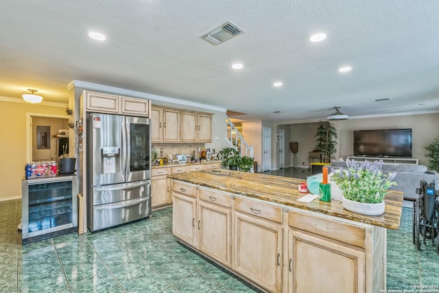 2102 Border Ml, San Antonio, TX 78230 - kitchen featuring stainless steel refrigerator with ice dispenser, light brown cabinets, beverage cooler, ornamental molding, and a center island
