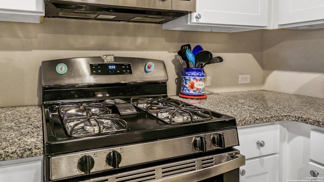 7207 Rosada Way, San Antonio, TX 78218 - kitchen view of stainless steel gas stove, white cabinets, and extractor fan