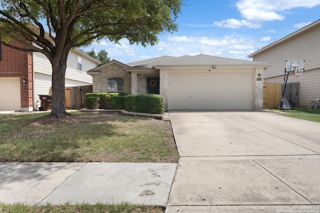 10410 Appaloosa Bay, San Antonio, TX 78254 - view of front facade featuring driveway, stone siding, and a garage