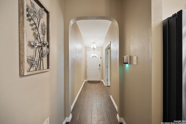 10410 Appaloosa Bay, San Antonio, TX 78254 - corridor featuring arched walkways and dark wood-type flooring