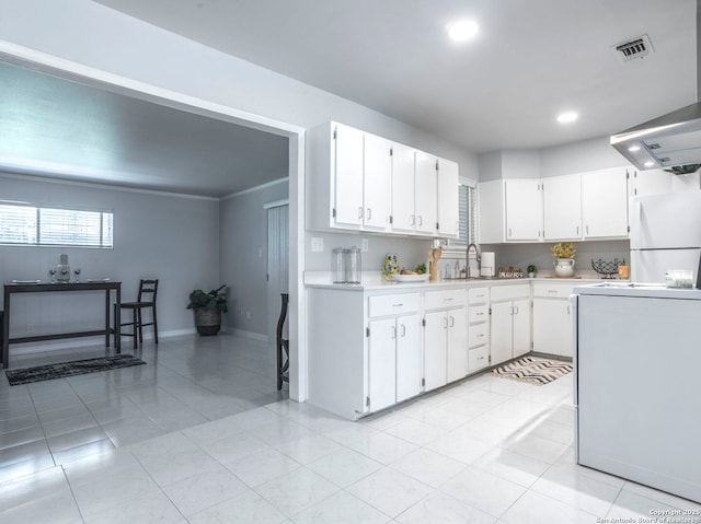 131 Hartford, San Antonio, TX 78223 - kitchen featuring freestanding refrigerator, light countertops, white cabinetry, light tile patterned floors, and recessed lighting