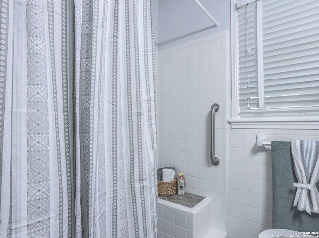 131 Hartford, San Antonio, TX 78223 - bathroom featuring a shower with shower curtain and tile walls