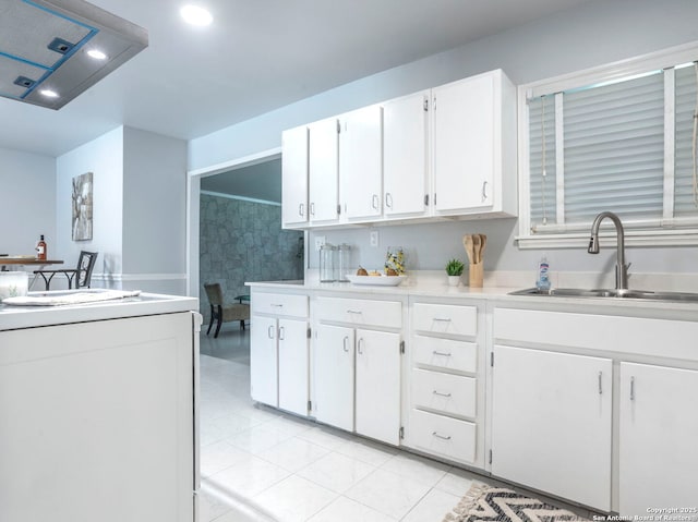 131 Hartford, San Antonio, TX 78223 - kitchen with white cabinetry, range, exhaust hood, light countertops, and light tile patterned floors