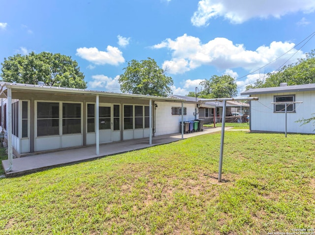 131 Hartford, San Antonio, TX 78223 - rear view of house with a patio, a yard, and a sunroom