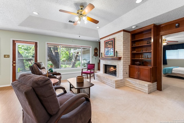 3523 Red Oak, San Antonio, TX 78230 - living area featuring a textured ceiling, a ceiling fan, a fireplace, a tray ceiling, and recessed lighting