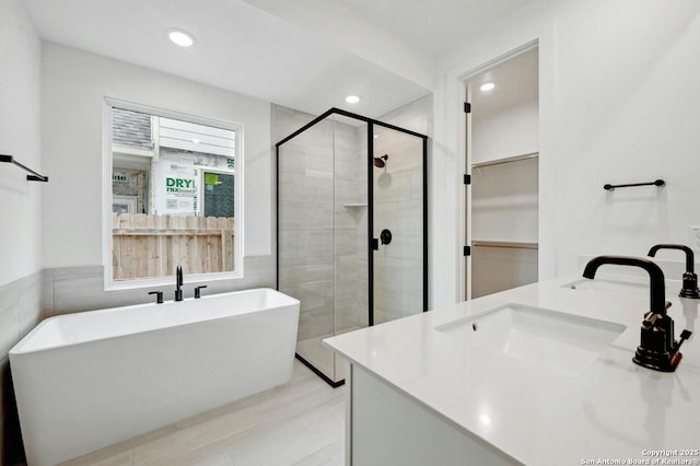 233 Alpine, New Braunfels, TX 78130 - full bath featuring a stall shower, double vanity, a freestanding tub, recessed lighting, and a spacious closet