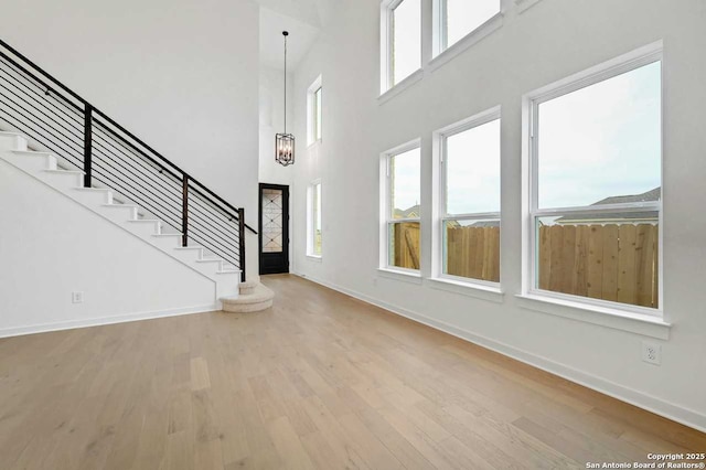 233 Alpine, New Braunfels, TX 78130 - foyer entrance with wood finished floors, stairway, and a towering ceiling