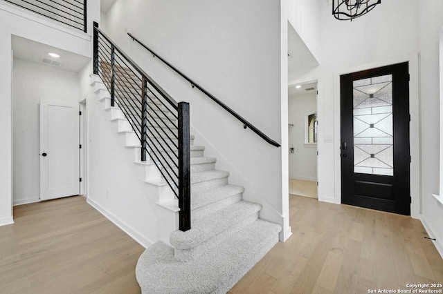 233 Alpine, New Braunfels, TX 78130 - foyer entrance featuring stairs, wood finished floors, and a towering ceiling