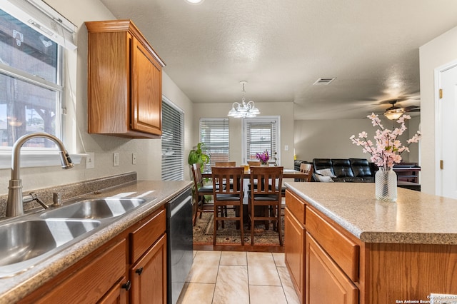 10223 Cactus Vly, San Antonio, TX 78254 - kitchen featuring dishwasher, brown cabinetry, open floor plan, decorative light fixtures, and a chandelier