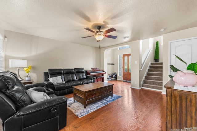 10223 Cactus Vly, San Antonio, TX 78254 - living room with wood finished floors, a ceiling fan, a textured ceiling, stairs, and arched walkways