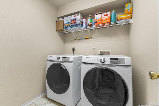 10223 Cactus Vly, San Antonio, TX 78254 - laundry area featuring washing machine and clothes dryer and light tile patterned floors