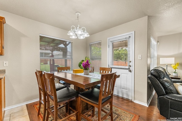 10223 Cactus Vly, San Antonio, TX 78254 - dining area with a chandelier, wood finished floors, and a textured ceiling