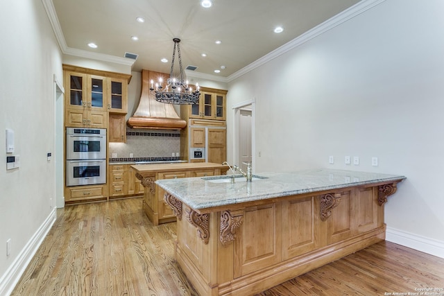 600 Thelma, Olmos Park, TX 78212 - kitchen with custom range hood, stainless steel appliances, recessed lighting, a peninsula, and light wood-style flooring