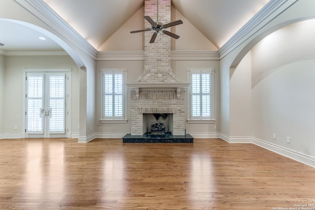 600 Thelma, Olmos Park, TX 78212 - unfurnished living room featuring a ceiling fan, wood finished floors, a brick fireplace, high vaulted ceiling, and french doors