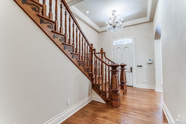 600 Thelma, Olmos Park, TX 78212 - entryway featuring crown molding, wood finished floors, a chandelier, stairway, and arched walkways