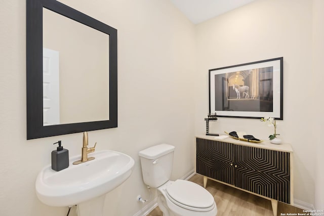 1587 Vista View Dr, Pleasanton, TX 78064 - half bathroom featuring a sink and wood finished floors