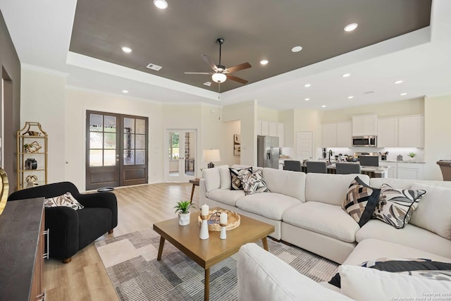 1587 Vista View Dr, Pleasanton, TX 78064 - living room featuring a raised ceiling, light wood-style floors, ceiling fan, and recessed lighting