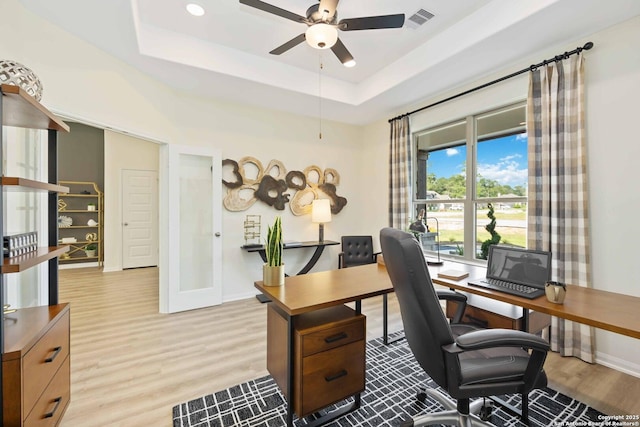 1587 Vista View Dr, Pleasanton, TX 78064 - office with ceiling fan, light wood-style floors, and a tray ceiling