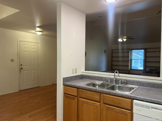 1503 Jami, Pleasanton, TX 78064 - kitchen with dishwasher, wood finished floors, dark countertops, ceiling fan, and brown cabinetry