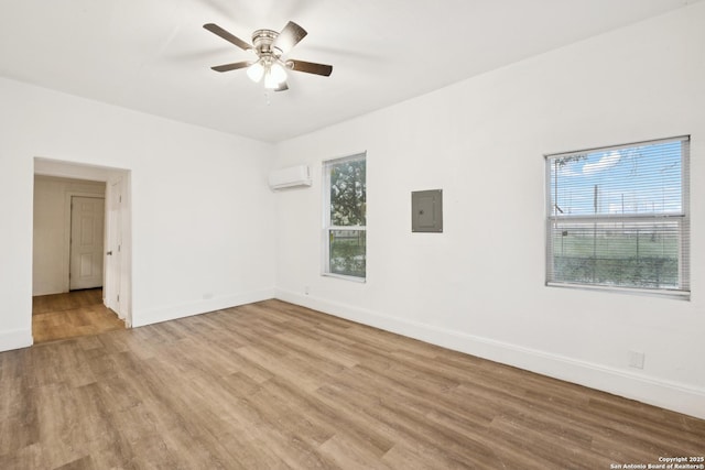 102 Aganier Ave, San Antonio, TX 78212 - spare room with an AC wall unit, wood finished floors, ceiling fan, and electric panel