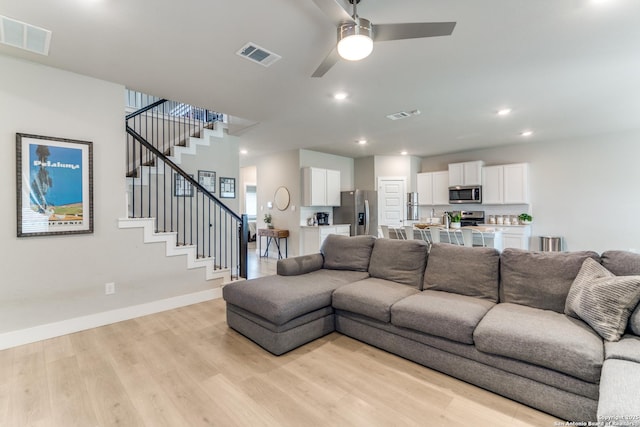 29125 Rock Cyn, Bulverde, TX 78163 - living area featuring light wood finished floors, ceiling fan, stairway, and recessed lighting