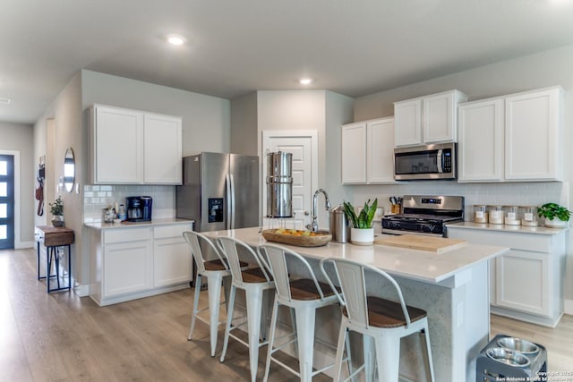 29125 Rock Cyn, Bulverde, TX 78163 - kitchen featuring stainless steel appliances, backsplash, light countertops, light wood-style floors, and recessed lighting