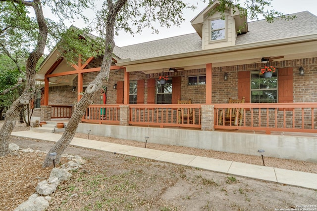 1777 Crossbow, Canyon Lake, TX 78133 - view of front facade with covered porch, brick siding, and a shingled roof