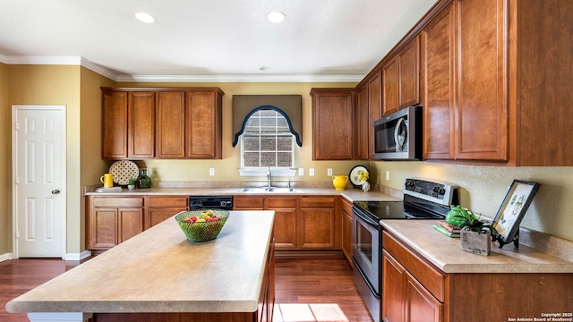 8023 Jalane Oaks, San Antonio, TX 78255 - kitchen with stainless steel appliances, dark wood finished floors, light countertops, brown cabinets, and ornamental molding