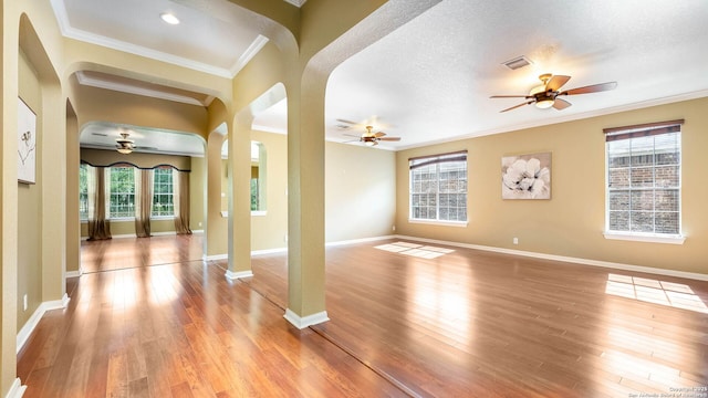 8023 Jalane Oaks, San Antonio, TX 78255 - foyer featuring ceiling fan, crown molding, arched walkways, and light wood-type flooring