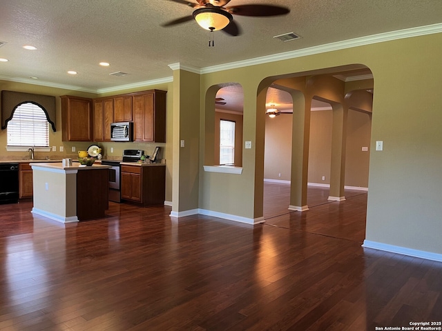 8023 Jalane Oaks, San Antonio, TX 78255 - kitchen with stainless steel appliances, ceiling fan, arched walkways, dark wood finished floors, and ornamental molding
