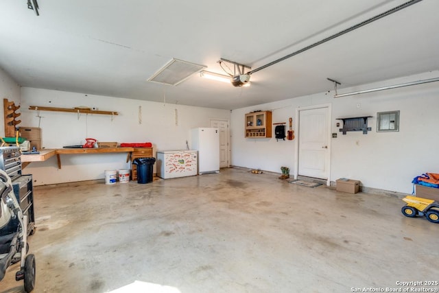 812 Riviere, Falls City, TX 78113 - garage featuring freestanding refrigerator, a garage door opener, and fridge