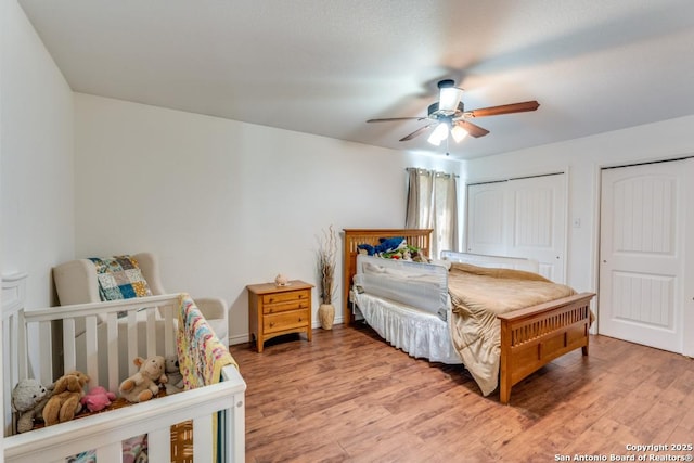 812 Riviere, Falls City, TX 78113 - bedroom featuring light wood-style floors, ceiling fan, and multiple closets