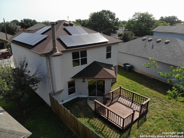 5615 Camry Spgs, San Antonio, TX 78251 - back of house with roof mounted solar panels, a deck, a yard, and roof with shingles
