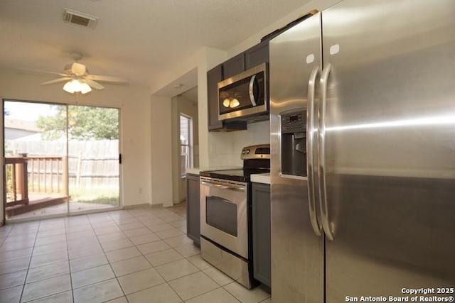 5615 Camry Spgs, San Antonio, TX 78251 - kitchen featuring appliances with stainless steel finishes, ceiling fan, light tile patterned floors, and light countertops
