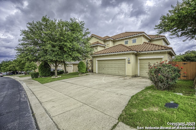 18306 Muir Glen Dr, San Antonio, TX 78257 - mediterranean / spanish-style home featuring an attached garage, driveway, stucco siding, and a tile roof