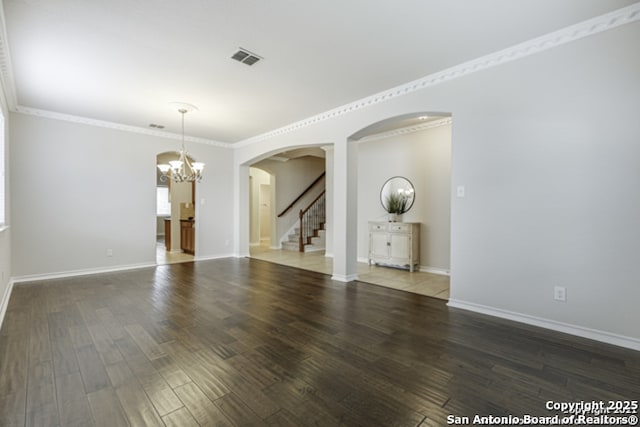 18306 Muir Glen Dr, San Antonio, TX 78257 - unfurnished room with a chandelier, arched walkways, wood finished floors, stairs, and ornamental molding