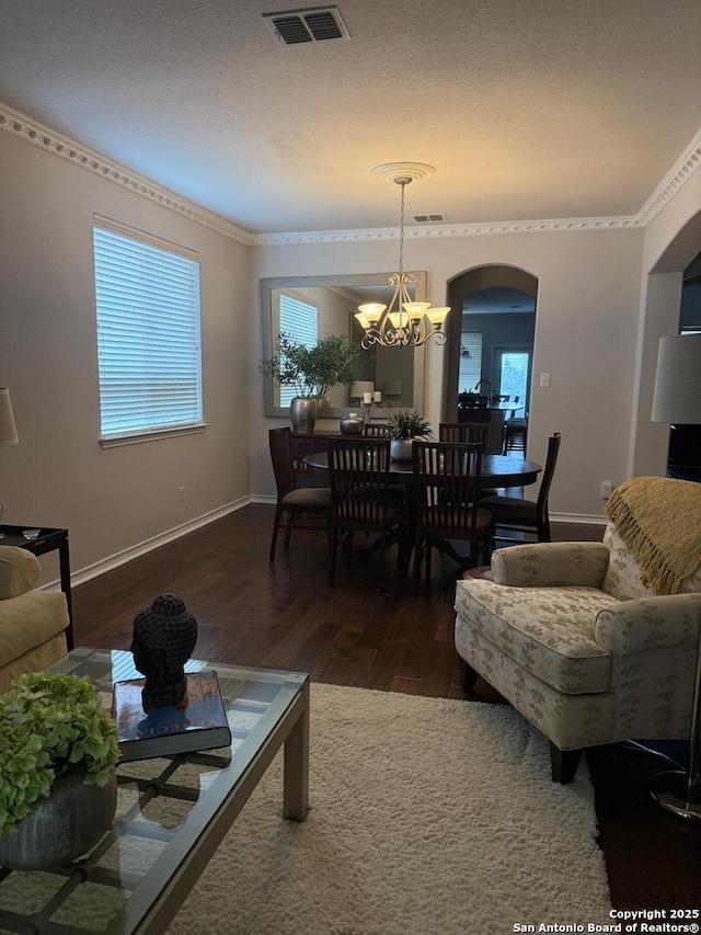 18306 Muir Glen Dr, San Antonio, TX 78257 - living area with a chandelier, wood finished floors, arched walkways, and crown molding