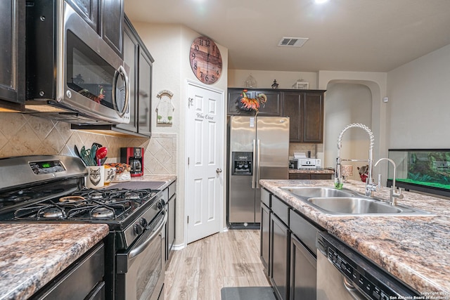 6018 Pearl Pass, San Antonio, TX 78222 - kitchen with appliances with stainless steel finishes, decorative backsplash, light wood-style floors, and light countertops