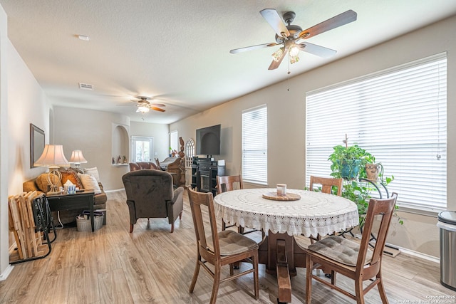 6018 Pearl Pass, San Antonio, TX 78222 - dining space with ceiling fan, light wood-style flooring, and arched walkways