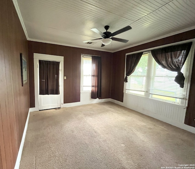 335 E San Antonio St, Marion, TX 78124 - spare room featuring ornamental molding, carpet, ceiling fan, and wooden walls