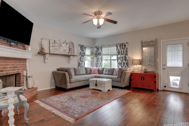 1154 Kite, New Braunfels, TX 78130 - living room featuring ceiling fan, dark wood-type flooring, and a brick fireplace