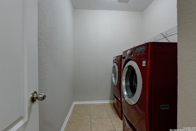 1154 Kite, New Braunfels, TX 78130 - laundry room featuring separate washer and dryer, light tile patterned floors, a textured ceiling, and a textured wall