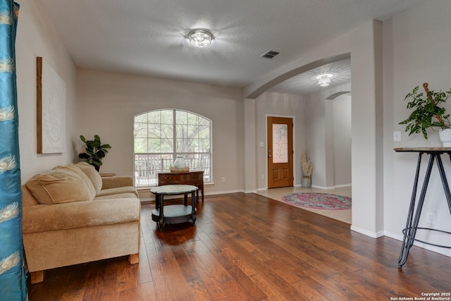1154 Kite, New Braunfels, TX 78130 - foyer entrance featuring arched walkways, wood-type flooring, and a textured ceiling