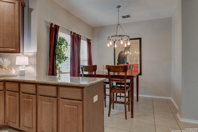 1154 Kite, New Braunfels, TX 78130 - kitchen featuring a chandelier, light tile patterned flooring, pendant lighting, backsplash, and light countertops