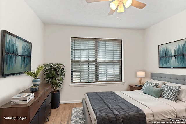 10955 Wurzbach Unit 306, San Antonio, TX 78230 - bedroom featuring light wood-style flooring and a ceiling fan