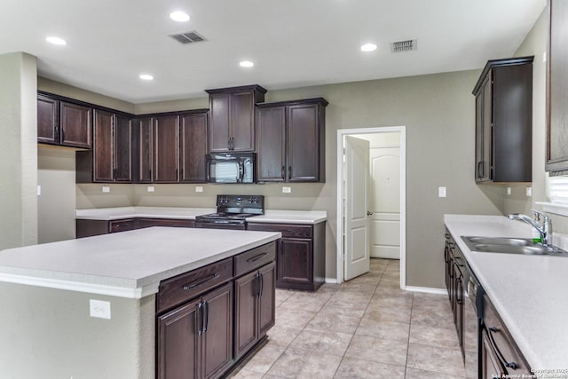 129 Sandy Shl, Boerne, TX 78006 - kitchen featuring black appliances, dark brown cabinetry, light countertops, and recessed lighting
