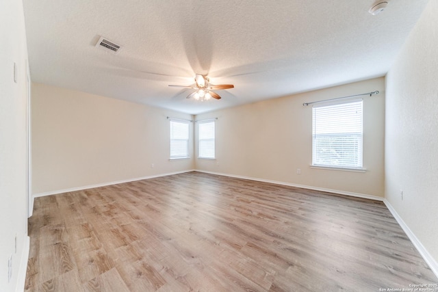 129 Sandy Shl, Boerne, TX 78006 - unfurnished room with ceiling fan, light wood finished floors, a smoke detector, and a textured ceiling