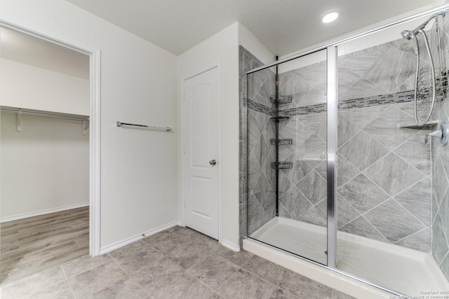 129 Sandy Shl, Boerne, TX 78006 - full bathroom featuring a shower stall, a spacious closet, and recessed lighting